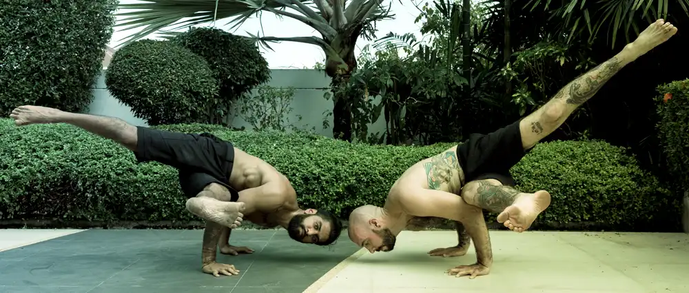 Two fit, lean, strong men exercising.
