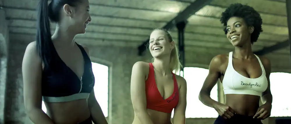 3 women relaxing after exercising.