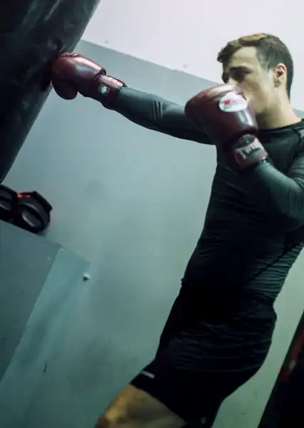 Man boxing, hitting the heavy-bag