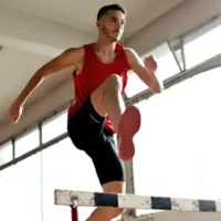 How to Reach Your Goals - The Secrets to Achieving Your Dreams Man leaping over hurdle.