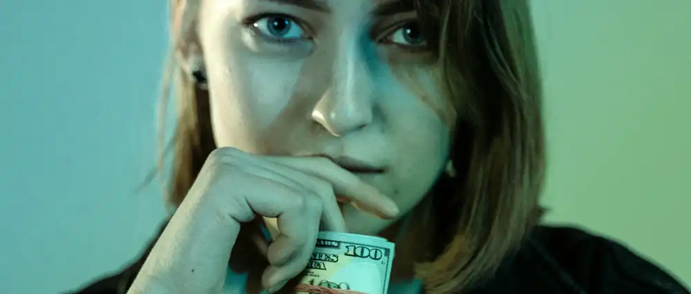 Woman with a roll of cash in hand.