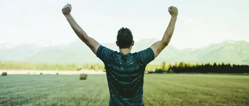 Man with arms raised in celebration.