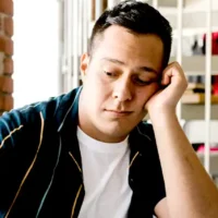 Why Do I Procrastinate So Much? Real Reasons & How to Stop Frustrated looking man with laptop.