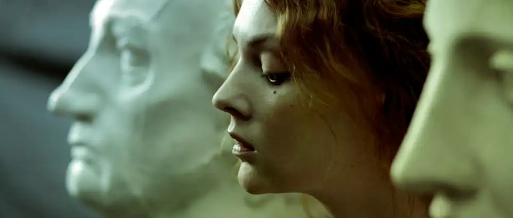 Woman thinking between two marble statues.