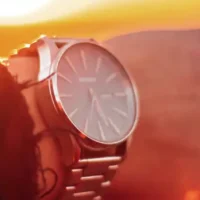 How to Manage Time Effectively Close up of a man wearing a watch with the sunset in background. Photo by Lawless Capture - unsplash.com