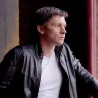 Man looking out of window. Photo by leva - pixabay